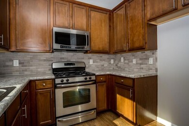 Kitchen with stainless steel appliances, wood fini