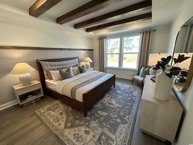 Bedroom with dark wood-style floors, beamed ceilin