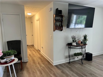 Corridor with wood finished floors and baseboards