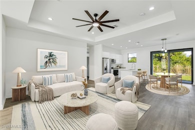 Living room featuring a raised ceiling, sink, and