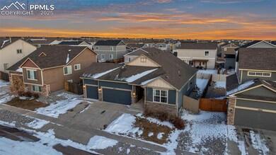 Aerial view of house featuring a three-car garage 