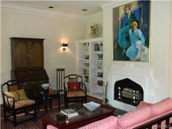 Formal living room has rich stuccoed walls, built-