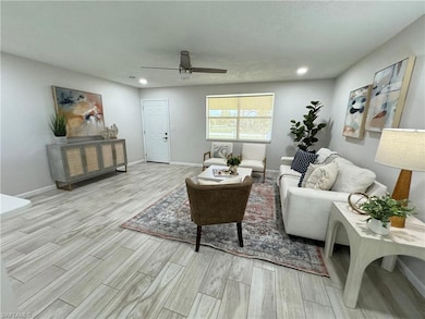 Living area with wood tiled floors, recessed lighting, a ceiling fan, and a textured ceiling