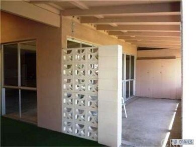 View of wraparound patio showing storage unit