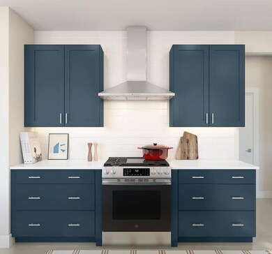 Kitchen with stainless steel vent hood