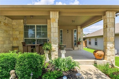Doorway to property with a porch and stone siding