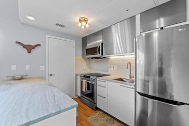 Kitchen with stainless steel appliances, a sink, 