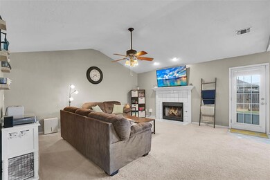 Living room with light carpet, lofted ceiling, a t