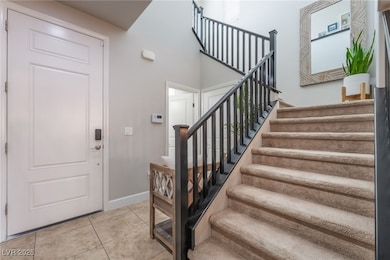 Foyer with stairway and tile patterned flooring