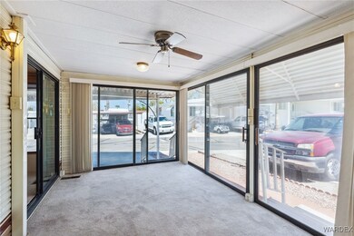 Sunroom featuring ceiling fan