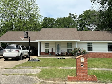 View of front of home featuring a carport, covered