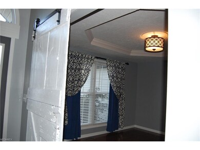 The dining room offers a tiered ceiling and the ev