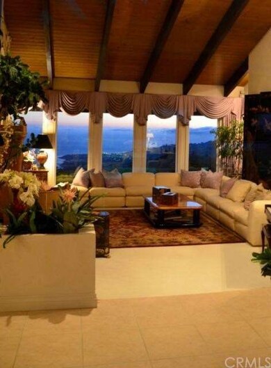 Living Room at night with coastal view in full glo
