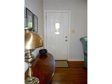 Foyer with newer front door and wood floors welcom