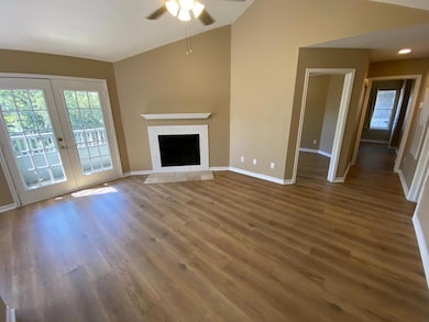 Unfurnished living room featuring ceiling fan, lo