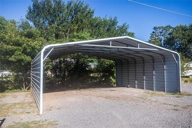 View of vehicle parking featuring a carport