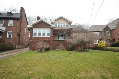 Front of house and spacious front yard.