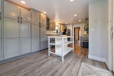 Kitchen with light hardwood / wood-style floors, t