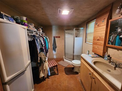 Bathroom with vanity, toilet, an enclosed shower, 
