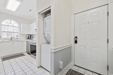Kitchen with light countertops, white cabinetry, s