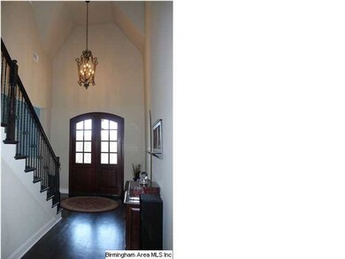The entry has a solid wood door with glass inset, 