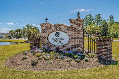 Community sign with a lawn and a water view