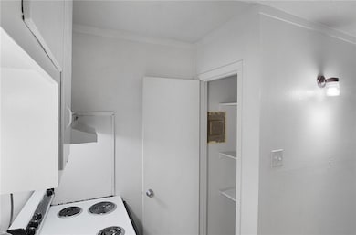 Kitchen with crown molding and white electric rang