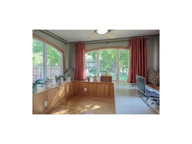Enclosed porch, windows on three sides, currently 