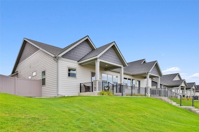 Rear view of property with a shingled roof and a patio