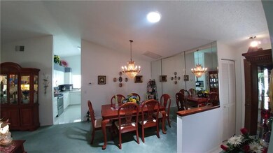 DINING ROOM WITH MIRRORED WALL.