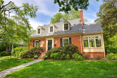Cape cod home featuring a front lawn
