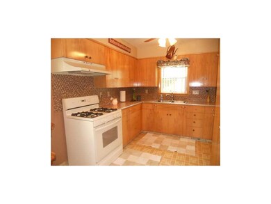 Kitchen. Lots of cabinets, and backsplash.