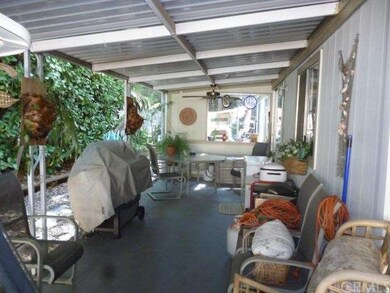 Covered front patio with ceiling fan