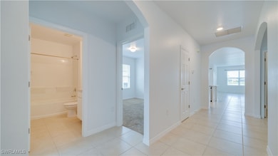 Hallway with arched walkways, light tile patterned