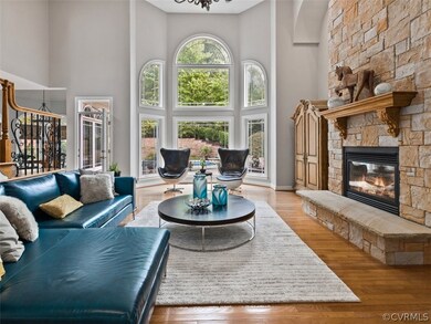 Two story family room with stone gas fireplace and