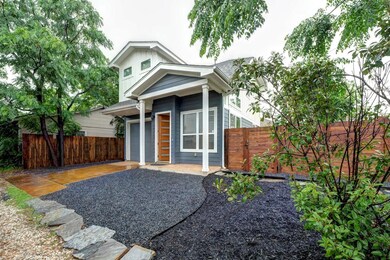 View of front of property featuring a garage, fen