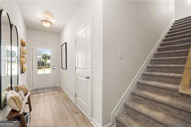 Doorway to outside featuring stairway, light wood 