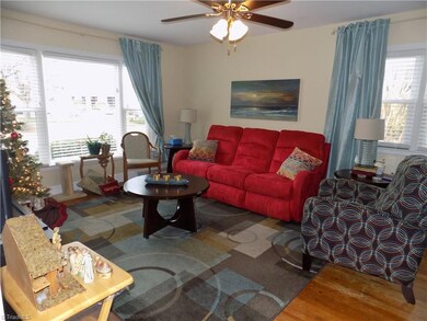 Cozy living room with updated ceiling fan.