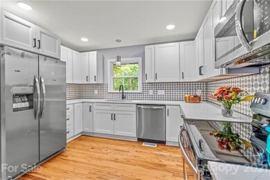Custom tile backsplash, granite countertops, natur