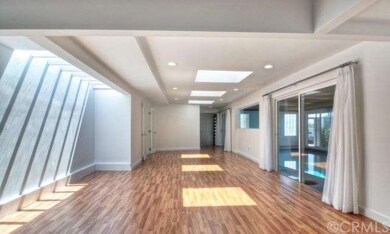 Bright and spacious great room with multiple skyli