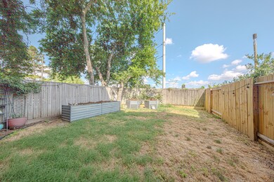 This backyard features a spacious fenced area with