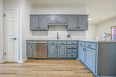 Kitchen featuring crown molding, light hardwood / 