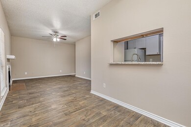 Unfurnished living room with ceiling fan, dark har