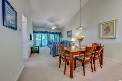 Dining room featuring light carpet, baseboards, high vaulted ceiling, and a ceiling fan