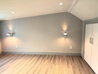 One bedroom with sconces for each side of the bed.