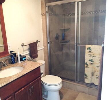 Sharp shower in modern bathroom with tiled floor a
