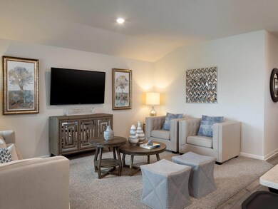 Living area with vaulted ceiling, baseboards, and