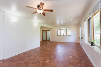 Off of the living to the left is an open area for the office.  This space leads out to an attached studio and greenhouse.