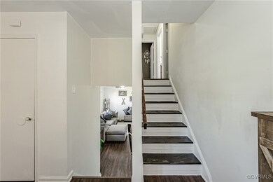 Staircase featuring baseboards and wood finished f