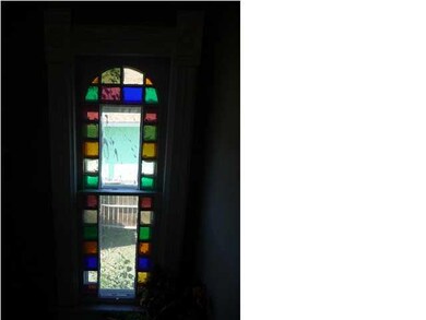 Great stained-glass window in stairway.